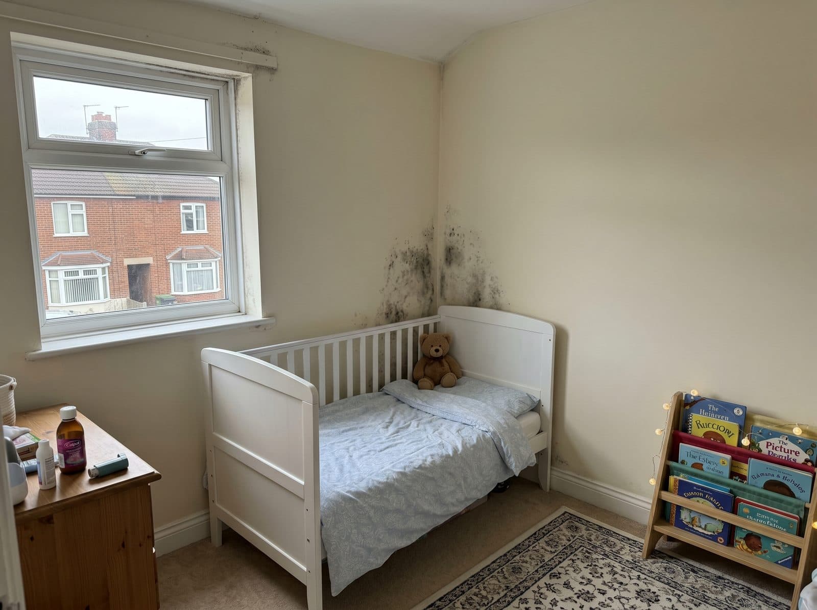 Child's bedroom with visible mould on the wall - family living with mould affecting their kids